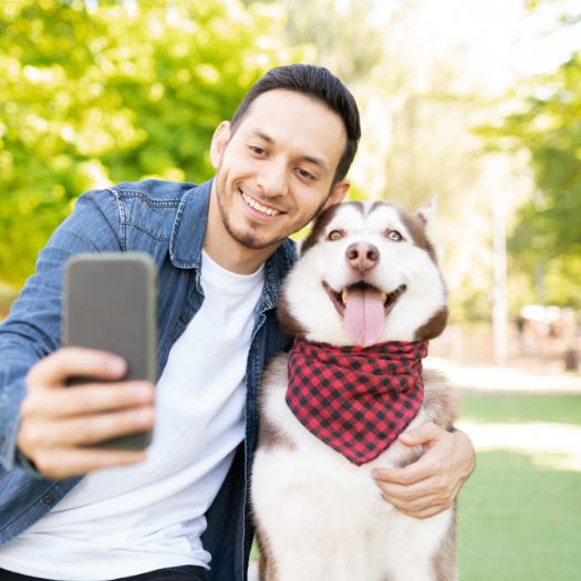 A person clicking selfie with dog